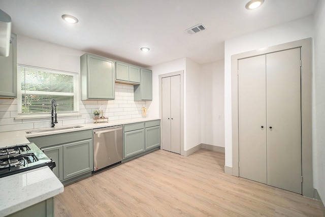 5525 Lester Granger Dr, Fort Worth, TX 76112 - kitchen featuring stainless steel dishwasher, light wood-style flooring, backsplash, green cabinetry, and recessed lighting