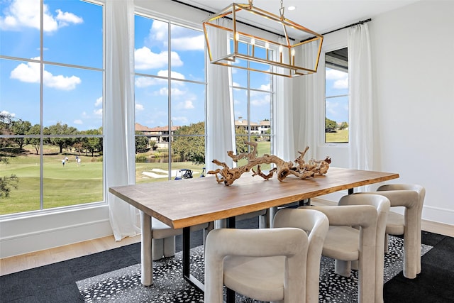 350 O Connor Ridge Blvd Unit 12, Irving, TX 75038 - dining area featuring a chandelier, plenty of natural light, wood finished floors, and view of golf course