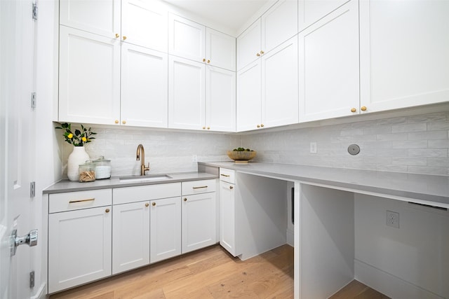 350 O Connor Ridge Blvd Unit 12, Irving, TX 75038 - kitchen featuring light wood finished floors, decorative backsplash, light countertops, and white cabinetry