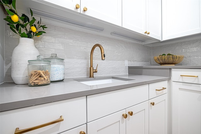 350 O Connor Ridge Blvd Unit 12, Irving, TX 75038 - kitchen with decorative backsplash, white cabinetry, and light countertops