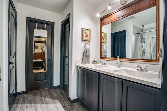 436 Buckeye Ave, Princeton, TX 75407 - full bathroom featuring wood finished floors, double vanity, and a shower