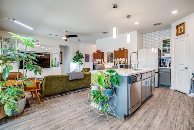 436 Buckeye Ave, Princeton, TX 75407 - kitchen with stainless steel dishwasher, light wood-type flooring, light countertops, and decorative light fixtures