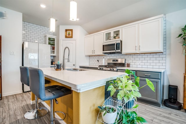 436 Buckeye Ave, Princeton, TX 75407 - kitchen featuring stainless steel appliances, decorative backsplash, light countertops, glass insert cabinets, and lofted ceiling