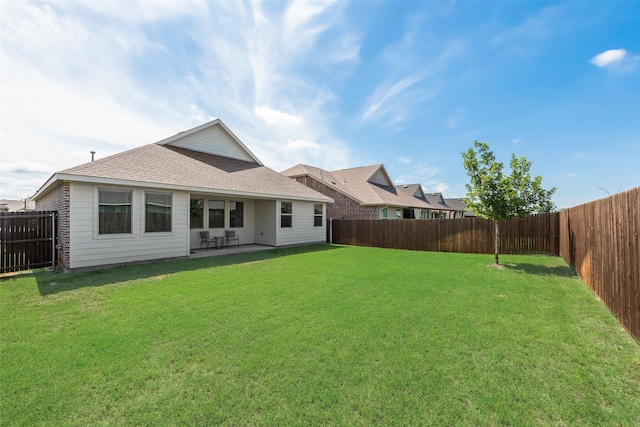 627 Beltrand Ln, Fate, TX 75087 - rear view of house featuring a fenced backyard, roof with shingles, and a patio area