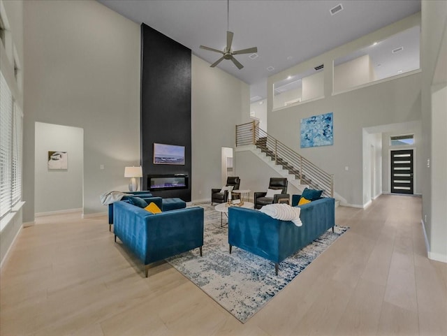 413 Coyote Creek Dr, Lavon, TX 75166 - living room with a high ceiling, stairway, wood finished floors, and ceiling fan