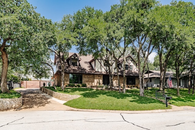 2304 Wakeforest Ct, Arlington, TX 76012 - tudor-style house featuring brick siding and driveway
