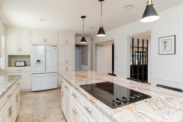 2304 Wakeforest Ct, Arlington, TX 76012 - kitchen with white fridge with ice dispenser, black electric cooktop, hanging light fixtures, light stone countertops, and recessed lighting