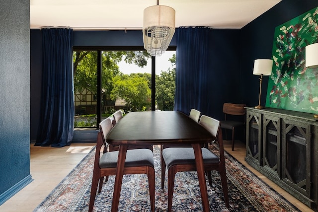 2304 Wakeforest Ct, Arlington, TX 76012 - dining space featuring a chandelier, wood finished floors, and a textured wall