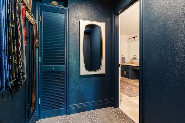 2304 Wakeforest Ct, Arlington, TX 76012 - bathroom featuring a textured wall and vanity