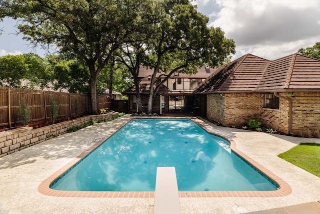 2304 Wakeforest Ct, Arlington, TX 76012 - view of pool with a fenced backyard, a diving board, and a patio