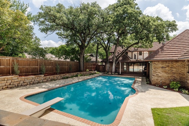 2304 Wakeforest Ct, Arlington, TX 76012 - view of swimming pool with a fenced backyard, a diving board, and a patio area