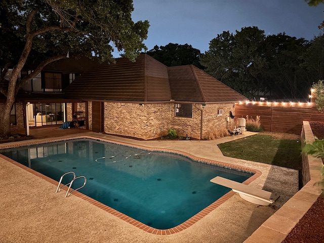 2304 Wakeforest Ct, Arlington, TX 76012 - view of swimming pool with a patio, a lawn, and a diving board