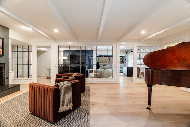 2304 Wakeforest Ct, Arlington, TX 76012 - living area featuring beamed ceiling, light wood finished floors, and a fireplace with raised hearth