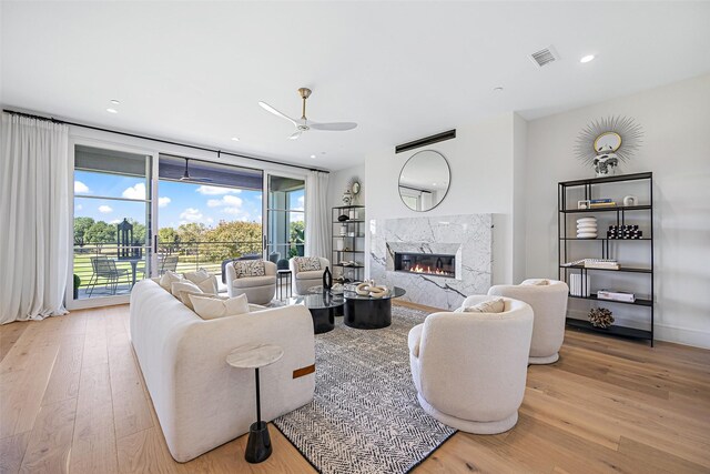 350 O Connor Ridge Blvd Unit 13, Irving, TX 75038 - living area featuring wood finished floors, plenty of natural light, a high end fireplace, ceiling fan, and recessed lighting