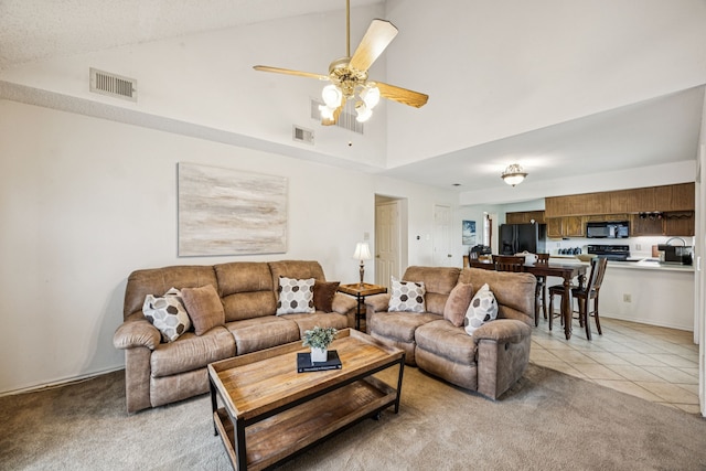 113 Windmill Ridge Dr, Rockwall, TX 75032 - living area with high vaulted ceiling, light colored carpet, ceiling fan, and light tile patterned floors