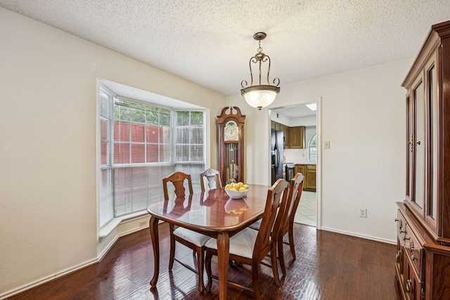 113 Windmill Ridge Dr, Rockwall, TX 75032 - dining space featuring dark wood-style floors and a textured ceiling
