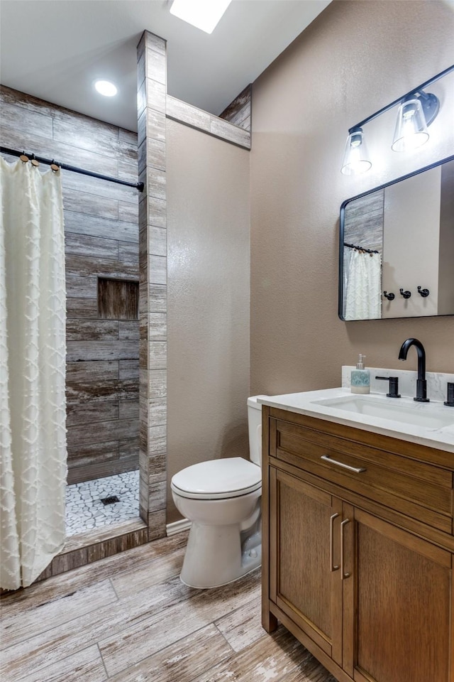 412 Paradise Canyon Cir, Paradise, TX 76073 - bathroom featuring vanity, wood finished floors, and a tile shower