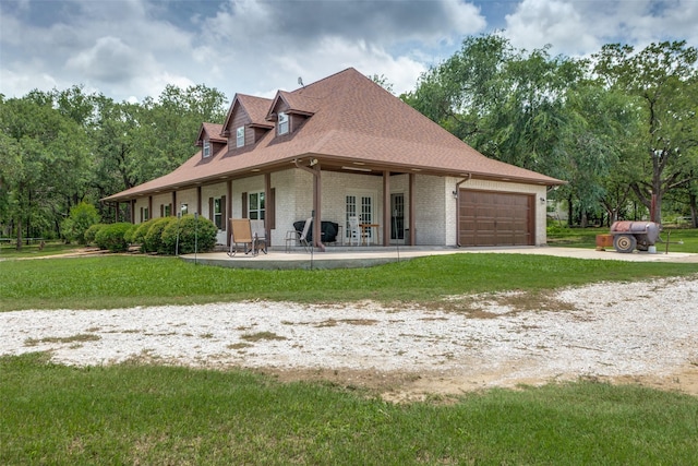 412 Paradise Canyon Cir, Paradise, TX 76073 - rear view of house with brick siding, an attached garage, a yard, driveway, and a patio area