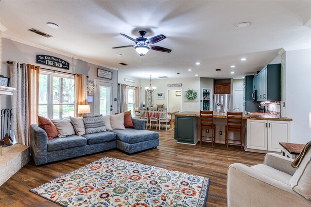 412 Paradise Canyon Cir, Paradise, TX 76073 - living area featuring ceiling fan, crown molding, dark wood-style flooring, a chandelier, and recessed lighting