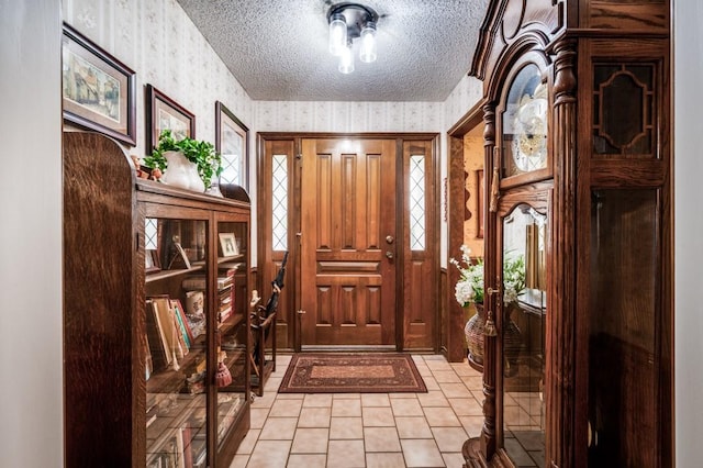 12869 Fm 1385, Pilot Point, TX 76258 - entrance foyer featuring wallpapered walls, light tile patterned flooring, a textured ceiling, and plenty of natural light