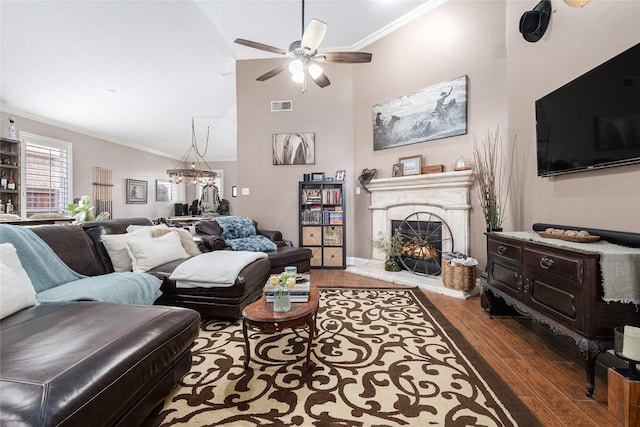 12953 Hurricane Ln, Fort Worth, TX 76244 - living area featuring ornamental molding, wood finished floors, ceiling fan, a lit fireplace, and a chandelier