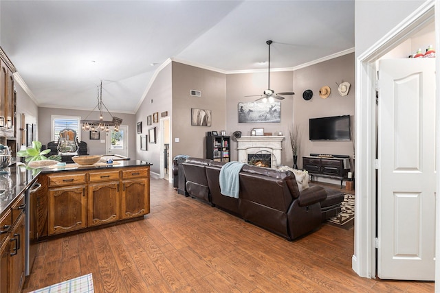 12953 Hurricane Ln, Fort Worth, TX 76244 - living room with a ceiling fan, wood finished floors, a lit fireplace, lofted ceiling, and a chandelier