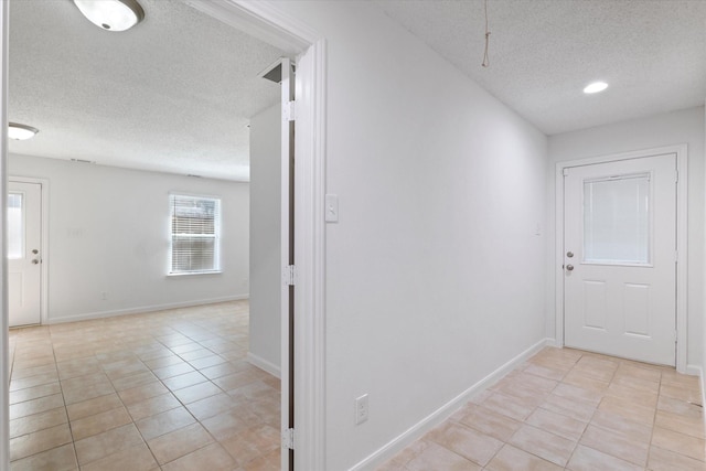 2206 Spring Leaf Dr, Carrollton, TX 75006 - corridor with a textured ceiling and light tile patterned flooring
