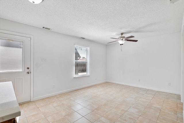2206 Spring Leaf Dr, Carrollton, TX 75006 - unfurnished room with ceiling fan, a textured ceiling, and light tile patterned floors