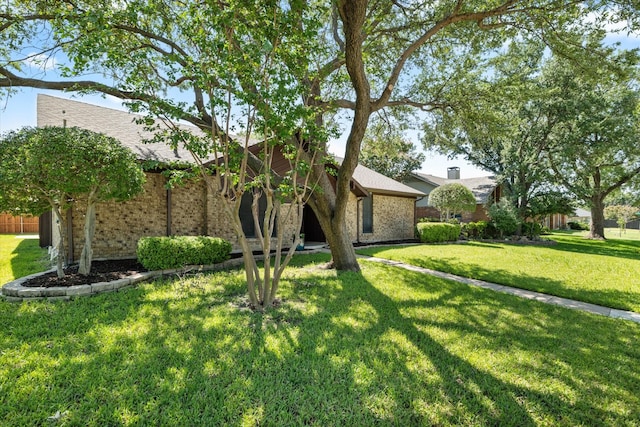2206 Spring Leaf Dr, Carrollton, TX 75006 - view of front of property featuring a front lawn and brick siding