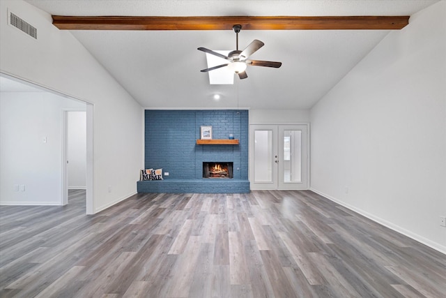 2206 Spring Leaf Dr, Carrollton, TX 75006 - unfurnished living room with a ceiling fan, wood finished floors, and a brick fireplace