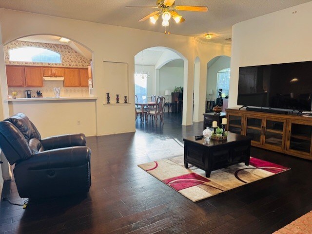 2322 Greenfield Cir, Garland, TX 75040 - living room with arched walkways, ceiling fan, and wood finished floors