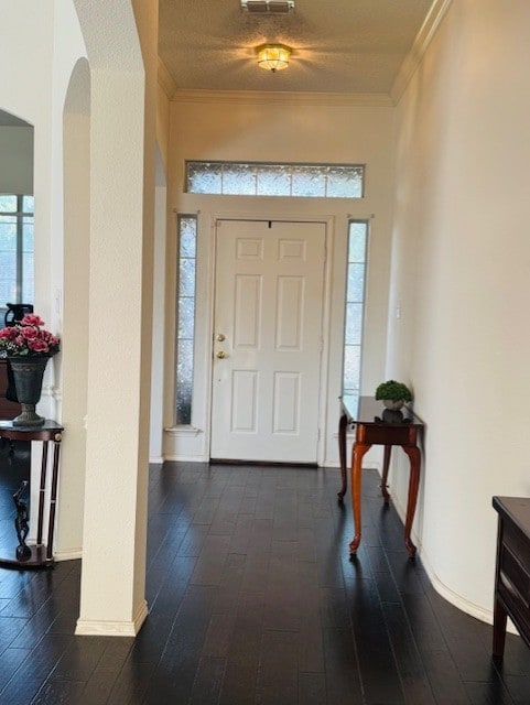 2322 Greenfield Cir, Garland, TX 75040 - entrance foyer with arched walkways, dark wood finished floors, and crown molding
