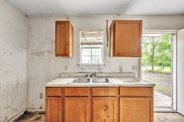 207 N 1st St, Crandall, TX 75114 - kitchen featuring light countertops and brown cabinetry
