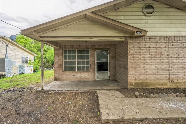 207 N 1st St, Crandall, TX 75114 - entrance to property with brick siding and a patio area