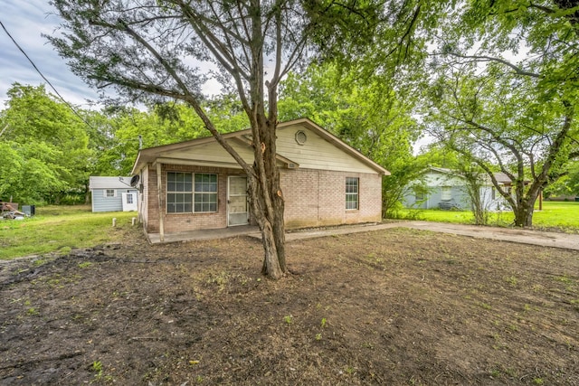 207 N 1st St, Crandall, TX 75114 - view of front of home with brick siding and a front yard