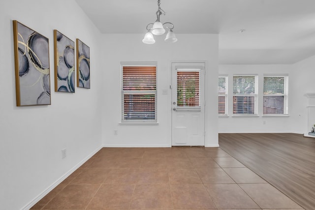 9700 Mulligan Dr, Mckinney, TX 75072 - unfurnished dining area with a chandelier and tile patterned floors