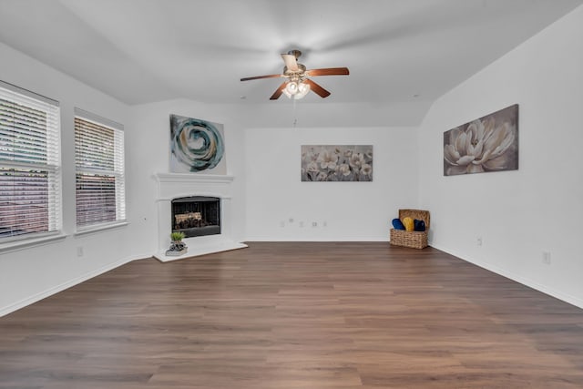 9700 Mulligan Dr, Mckinney, TX 75072 - unfurnished living room with a ceiling fan, lofted ceiling, a fireplace with raised hearth, and wood finished floors