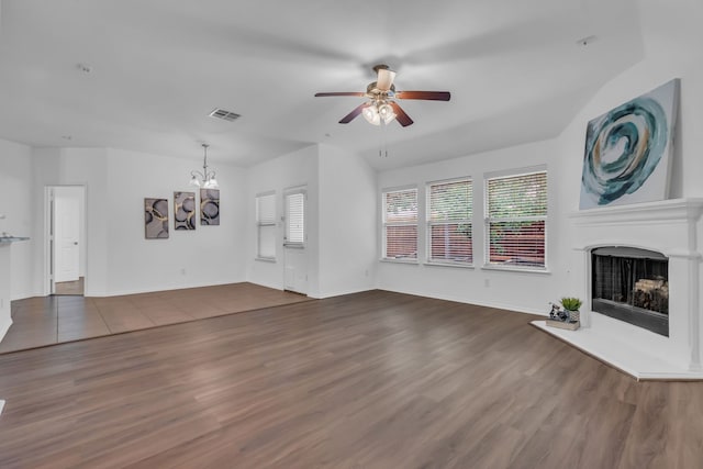 9700 Mulligan Dr, Mckinney, TX 75072 - unfurnished living room featuring ceiling fan, a chandelier, wood finished floors, and a fireplace with raised hearth
