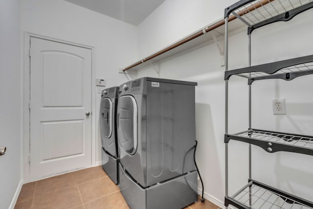 9700 Mulligan Dr, Mckinney, TX 75072 - laundry room featuring washer and dryer and light tile patterned floors