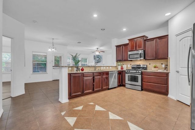 9700 Mulligan Dr, Mckinney, TX 75072 - kitchen featuring stainless steel appliances, a peninsula, backsplash, light tile patterned floors, and recessed lighting