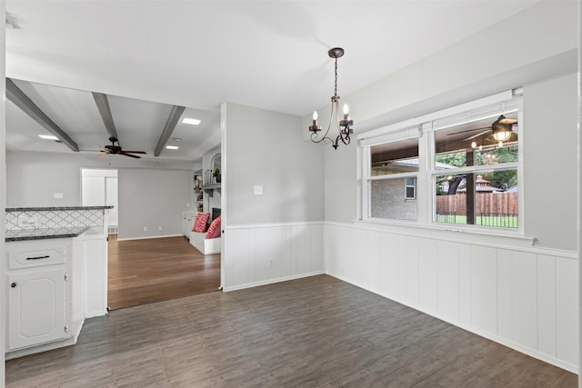 6767 Winifred Dr, Fort Worth, TX 76133 - unfurnished dining area with ceiling fan, a chandelier, wainscoting, and dark wood finished floors
