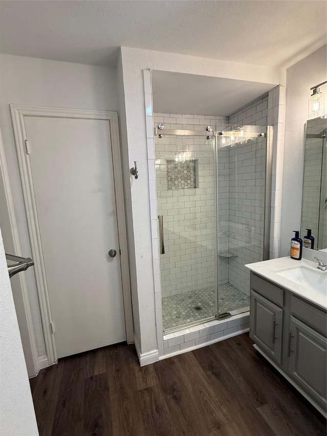2761 Stonecreek Dr, Carrollton, TX 75006 - bathroom with wood finished floors, vanity, and a stall shower