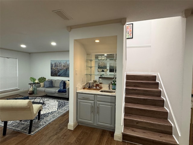 2761 Stonecreek Dr, Carrollton, TX 75006 - indoor wet bar featuring dark wood-style floors, recessed lighting, and stairs