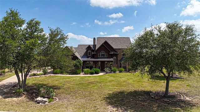 105 Lavender Pl, Mclendon Chisholm, TX 75032 - view of front of house with a front lawn, a standing seam roof, a metal roof, a chimney, and a porch
