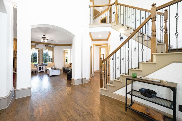 105 Lavender Pl, Mclendon Chisholm, TX 75032 - entryway featuring wood finished floors, a ceiling fan, crown molding, stairs, and arched walkways