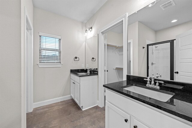 5500 Black Horse, Waco, TX 76708 - full bath featuring a shower stall, two vanities, a walk in closet, and recessed lighting