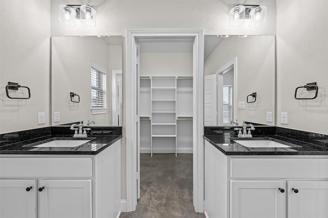 5500 Black Horse, Waco, TX 76708 - bathroom with two vanities, finished concrete floors, and a spacious closet