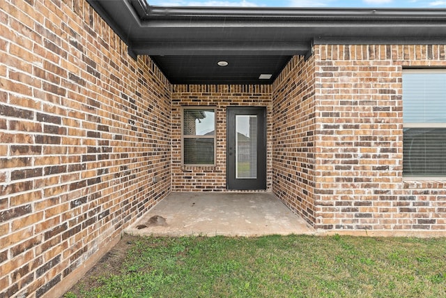 5500 Black Horse, Waco, TX 76708 - view of exterior entry with brick siding and a patio area