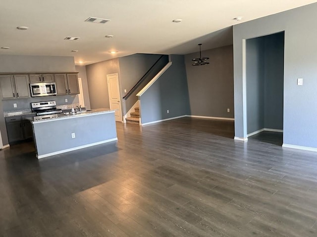 312 Wagon Wheel Dr, Josephine, TX 75189 - kitchen with stainless steel appliances, dark wood finished floors, a kitchen island with sink, open floor plan, and light countertops