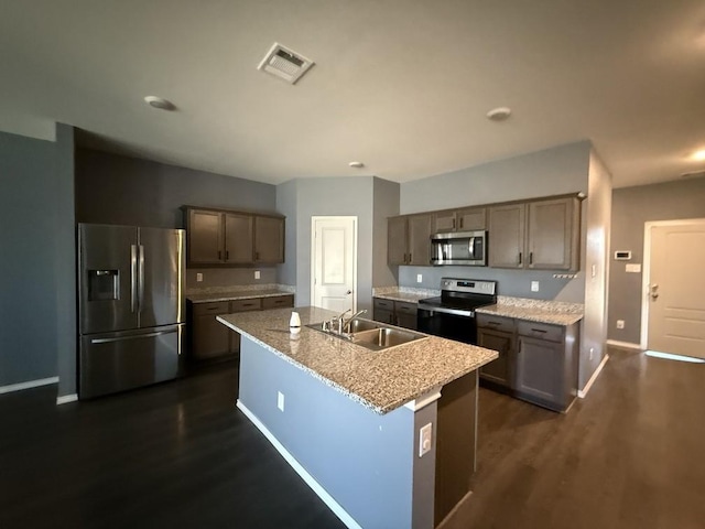 312 Wagon Wheel Dr, Josephine, TX 75189 - kitchen with appliances with stainless steel finishes, dark wood-type flooring, and an island with sink